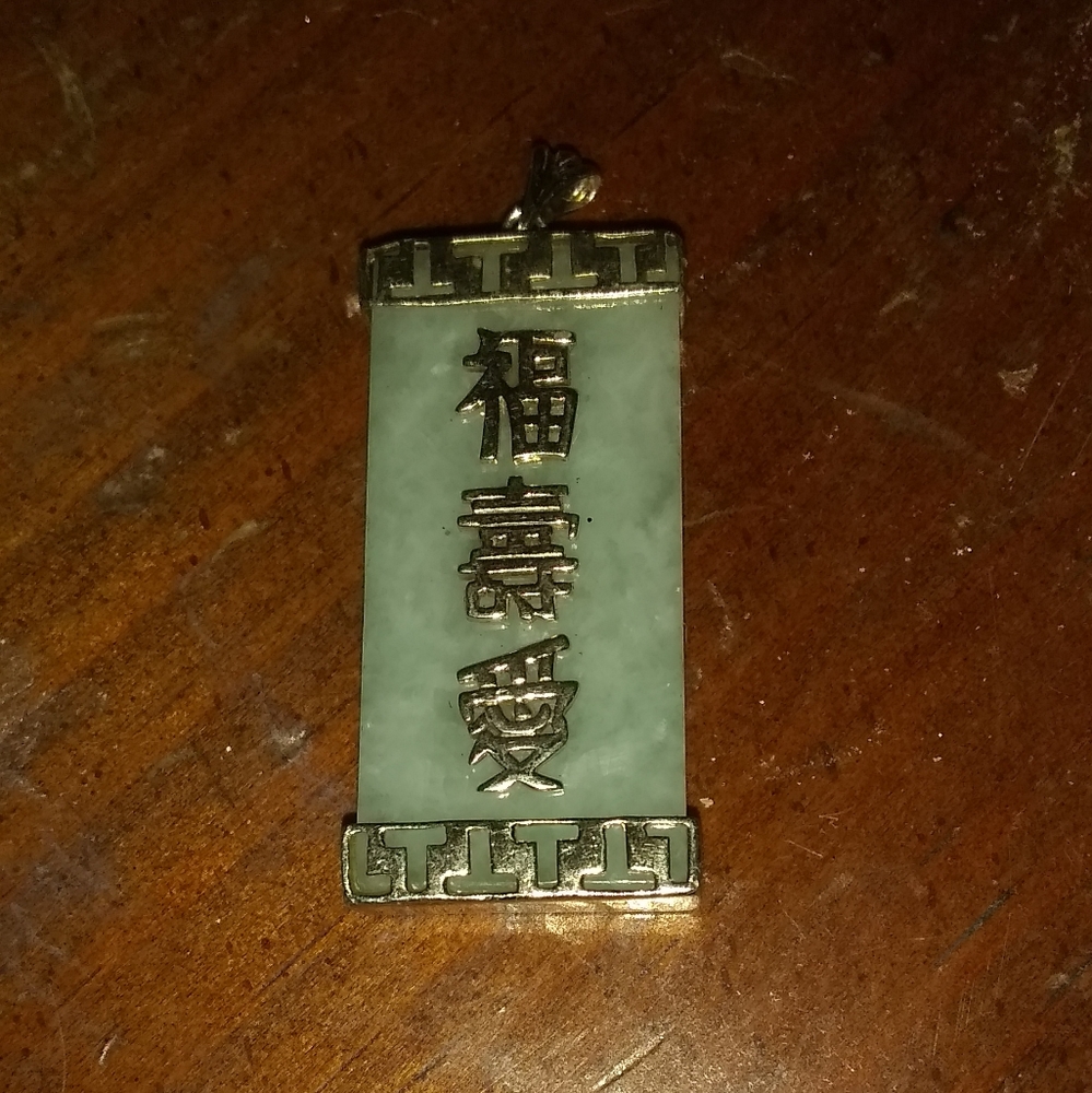 Chinese love gold charm on green stone